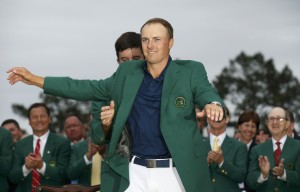 Defending champion Watson of the U.S. puts the traditional green jacket on compatriot Spieth after Spieth won the Masters golf tournament at the Augusta National Golf Course in Augusta