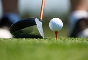 Up close image of a golf ball on tee with club